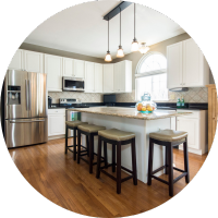 Kitchen with an island, bar stools and pendant lights